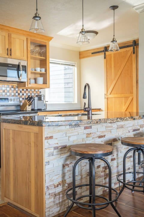 Cozy up at the island — perfect for coffee, cocktails, or keeping the chef company.