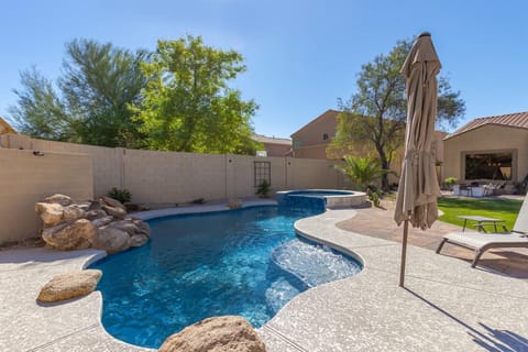 Private resort style backyard with sparkling pool and large lounge area