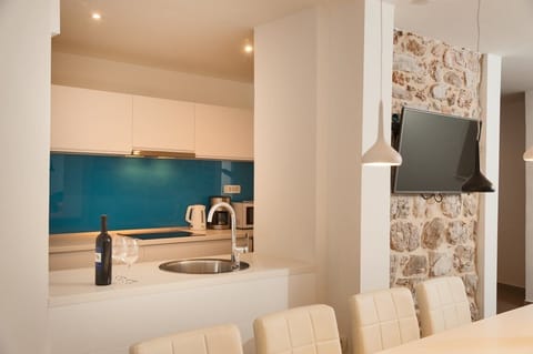 A view of the kitchen with a sink, induction hob, coffee machine and microwave oven in a luxury holiday villa in Bol