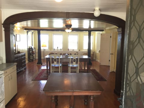 Large, open-concept kitchen, dining, and living room area with historic charm.