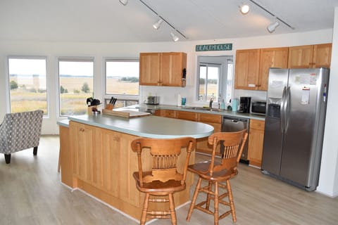 Kitchen with supplies in cupboard and island