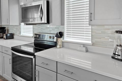 Kitchen has beautiful counters and tile backsplash!