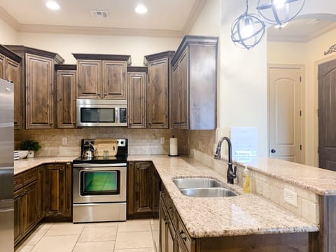 Fully stocked kitchen with table settings for 12