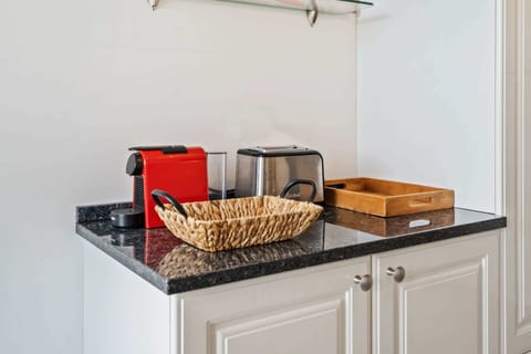 Convenient coffee and tea station with a modern coffee maker and toaster, perfect for starting your day right.