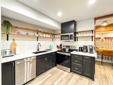 ...a stainless steel appliance suite, and open shelving.