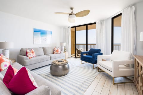 Spacious seating with modern coastal décor, large windows, and sweeping ocean views