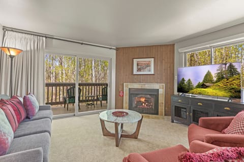 The living room offers comfortable furniture and a cozy fireplace and flat screen TV.