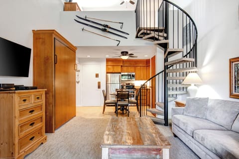 Snow Flower 31's open concept living room next to the dining and kitchen area with a Murphy Bed cabinet in the middle.