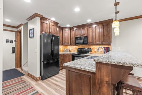 Your gourmet kitchen awaits with rich wood cabinets, granite counters, and full appliances.