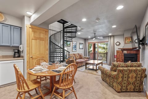 Snow Flower 72's dining area sitting next to a the living room with a cozy couch and love seat.