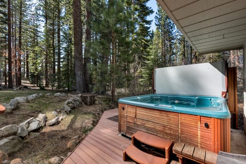 Relax in the private hot tub surrounded by serene forest views and the sounds of nature
