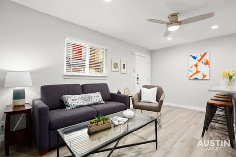 Open concept living room and kitchen with sleeper sofa and smart TV