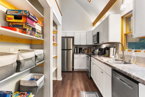 A set of shelves stocked with a variety of board games offers endless fun for family and friends.