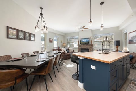 Open concept living, dining and kitchen area with views of the slope.