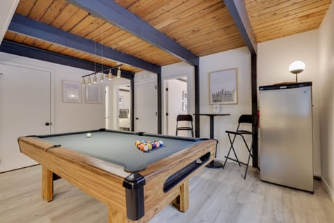 The game room features a pool table, lounge and TV area, extra fridge, and more!