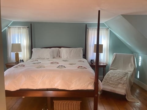 Master bedroom with king sized bed with memory foam mattress topper.