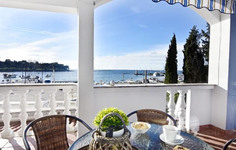 The terrace furnished with table and chairs where you can enjoy your coffee while admiring the sea