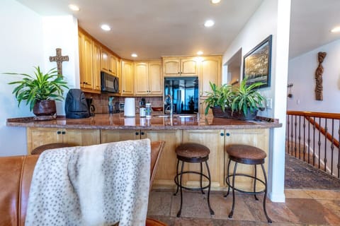 Fully equipped kitchen with bar stool seating at kitchen counter