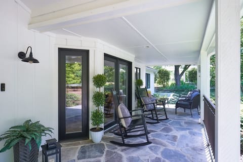 Comfortable front porch with rockers and seating to relax.