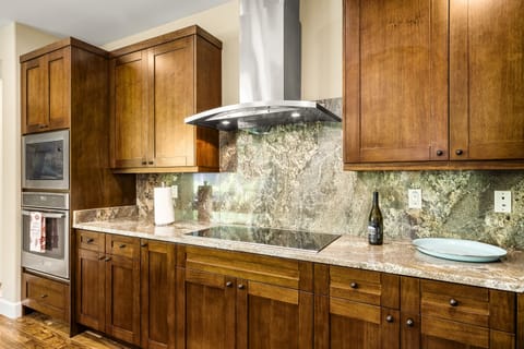 The oven range, built into the countertop, next to the microwave, and an oven built into the cabinetry.