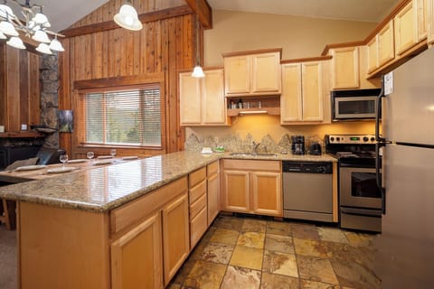 Your fully equipped kitchen features granite counters, maple cabinets, and stainless appliances—perfect for preparing memorable meals together.