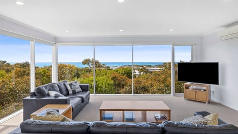 Upstairs, relax in the living room with a flat-screen TV and split-system air-conditioning. You'll also find impressive floor-to-ceiling glass panels that give you refreshing views of lush coastal forest and stunning views of the ocean's pristine azure wa