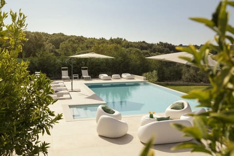 View of the outdoor terrace with sunbeds next to the private pool in the Croatia luxury villa for family vacations 