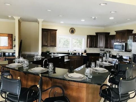 The back kitchen where people hang out, has LOTS of room around the high top.