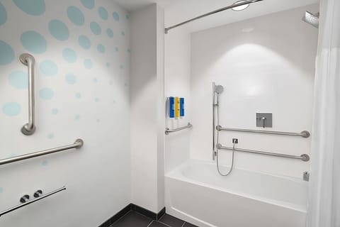 Bathroom with a shower and tub. Basic toiletries and towels are provided