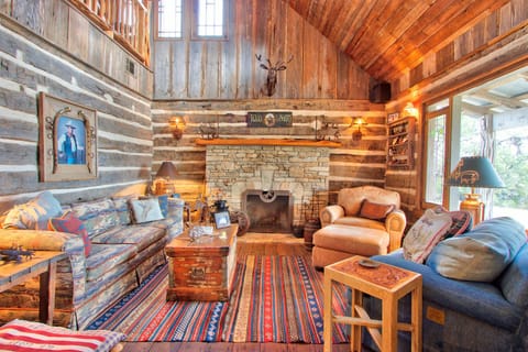As you enter the living room is to the right and features a stone fire place