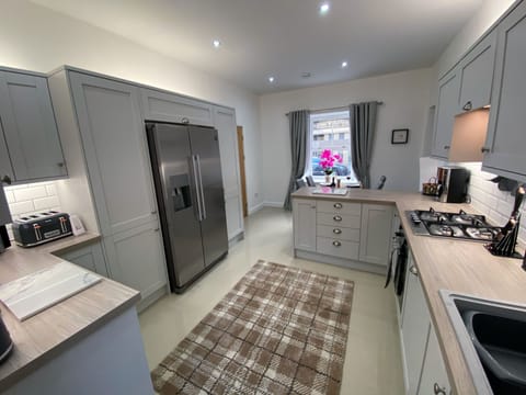 Kitchen with double size American fridge freezer and ice maker.