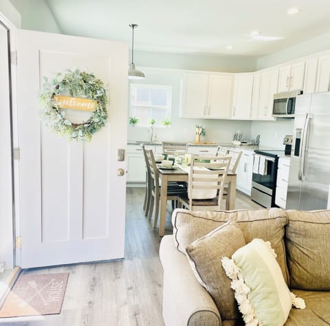 To your right is the living room, to your left is the fully equipped kitchen.