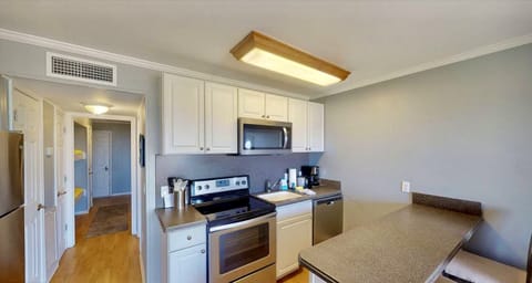 totally renovated kitchen with flat top stove and Corian countertops