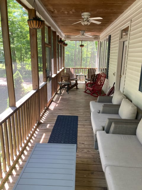 Front Porch featuring Couches and Adirondack Chairs