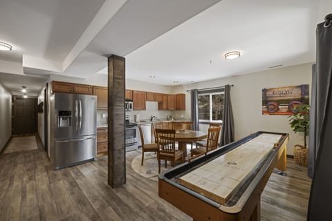 18' Championship Shuffle Board Table and Open Concept Living With Chef’s Kitchen, Full Dining Area And Cozy Lounge