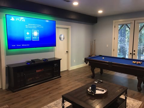 Game room with 82 inch tv, pool table and PS4 with plus subscription.