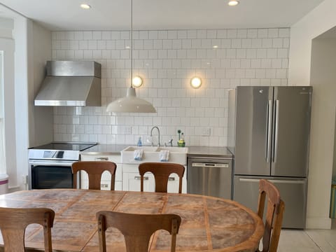 other side of kitchen with sink and refrigerator