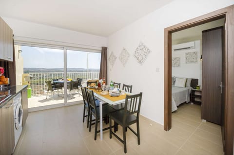 fully equipped kitchen and dining area overlooking the sunny terrace with views