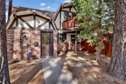 Welcoming cabin entry surrounded by towering pine trees, offering fresh mountain air and a peaceful forest setting—the perfect first impression for your Big Bear Lake getaway.
