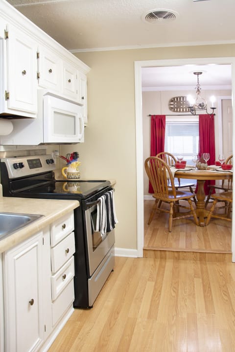 Stove oven and mounted microwave, positioned to the right of the sink.