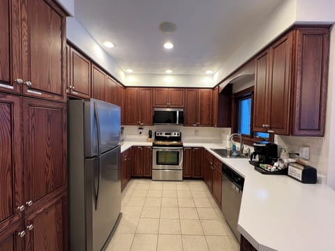 Fully equipped kitchen with modern appliances, cookware and dining essentials.