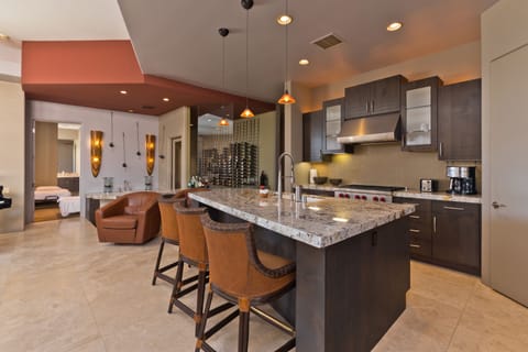 Chef's kitchen with marble countertops and high-end appliances.