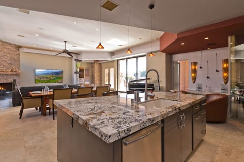 Chef's kitchen with marble countertops and high-end appliances.