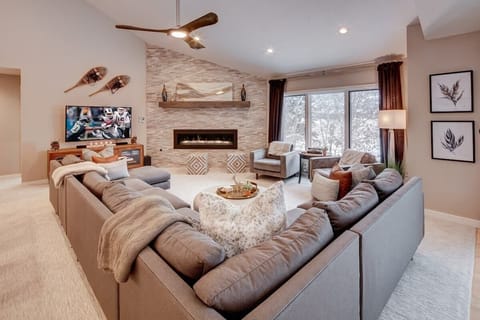 Huge living room / great room with plenty of comfortable seating for watching games or movies in front of the fireplace