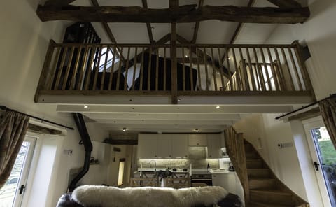 living area showing mezzanine floor over
