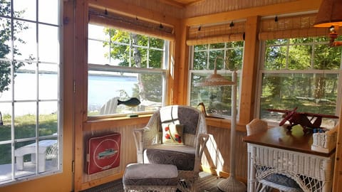 Enjoy lake views and a cup of coffee in the sunroom.