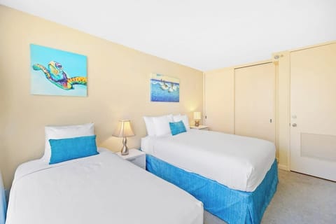 Bedroom with queen size bed and twin size bed, central AC and TV