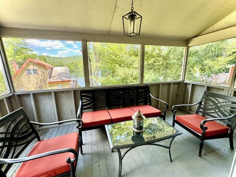 Covered outdoor patio with views of the lake, connecting to king bedroom