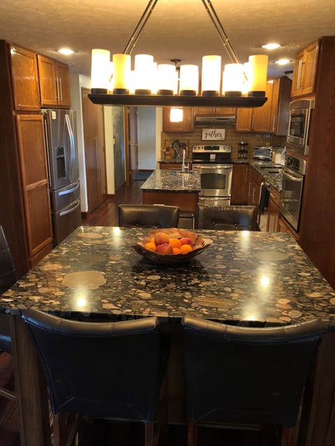 Counter top island in kitchen with seating for 6. Ample pantry space