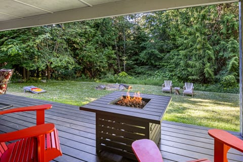 Firepit with 2 Adirondack chairs.. This portion of the deck is covered 